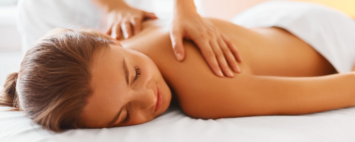 Massage therapist treating a client's back